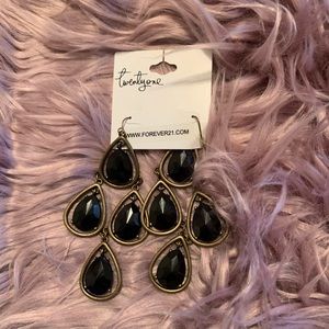 Women black and gold earrings.